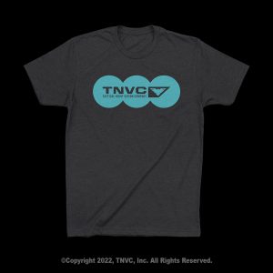 Dark gray shirt, blue TNVC circles, winged logo.