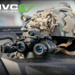 Thermal scope mounted on camo helmet, TNVC logo.