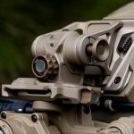 Tan SWIFT helmet mount with optic on rail.